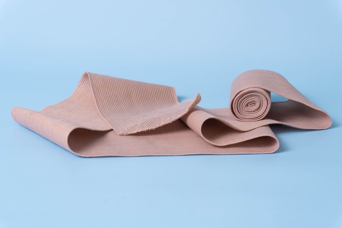 Rolled and folded elastic compression bandage