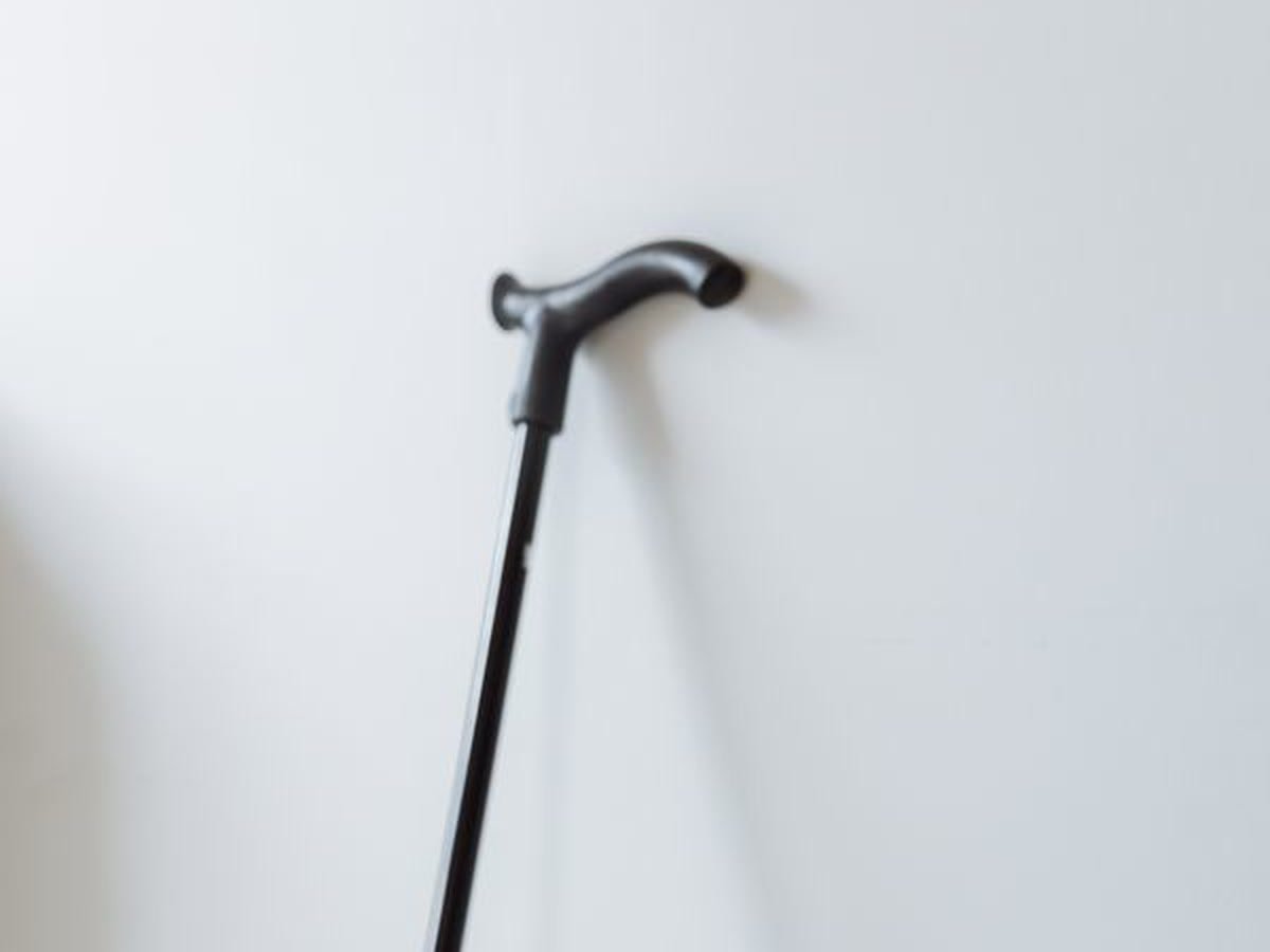 Black height-adjustable walking cane with a contoured handle